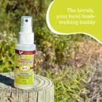 Natural mosquito repellent spray bottle on wooden stump in Australian outdoors - DEET free insect protection