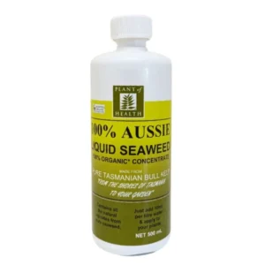 Bottle of Liquid Seaweed Concentrate placed in a greenhouse