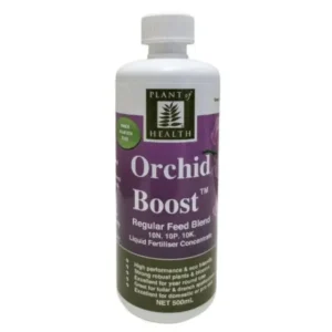 Bottle of Orchid Boost Concentrate Liquid Fertiliser on a shelf beside orchids