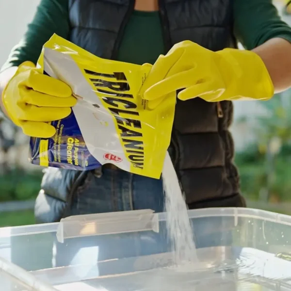 Person cleaning a mesh filter with Tricleanium Ultra Concentrated Cleaner 1kg - effective for grease, grime, and tough stains