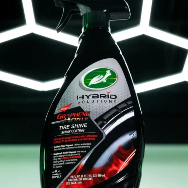 Close up of Turtle Wax Hybrid Solutions Graphene Tyre Shine 680ml bottle against background with hexagon lighting grid.