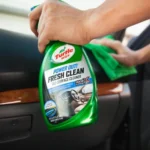 Turtle Wax Power Out Fresh Clean All-Surface Cleaner 680ml with infographic callouts showing odour removal, stain lift, and safe-for-all-surfaces message on white background