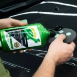 Turtle Wax Super Hard Shell Liquid Wax 473ml with infographic callouts highlighting long-lasting protection, mirror-like shine, and water-beading technology on white background